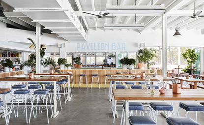 Burleigh Pavilion with blue table seat and wooden dinning table.