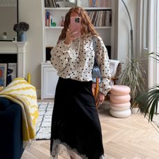 Influencer wears a lace-trim skirt.