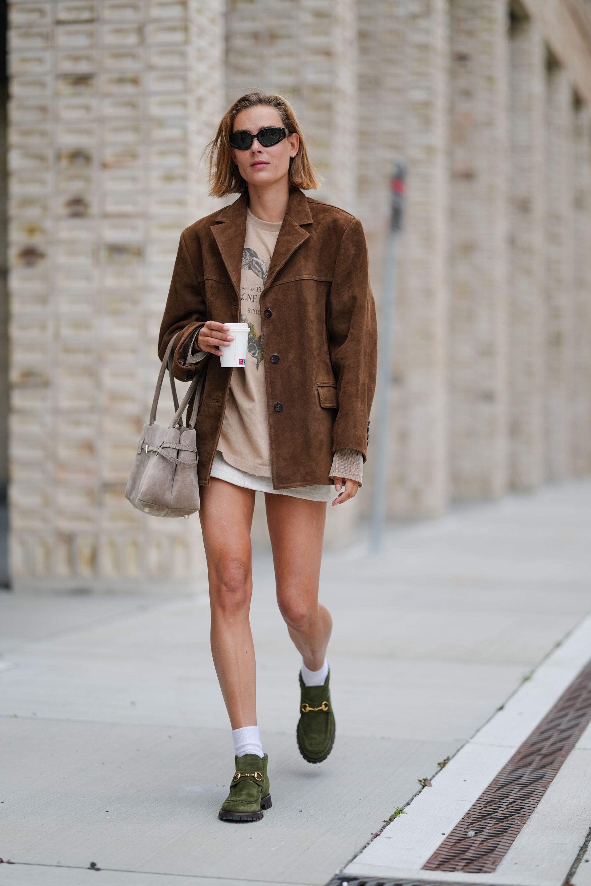 Woman in suede jacket and suede loafers