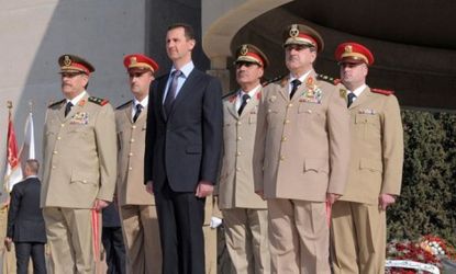 A 2011 photo shows Syrian President Bashar al-Assad with army leaders, including Defense Minister Daoud Rajha (front, right), who was killed in a rebel bombing July 18.