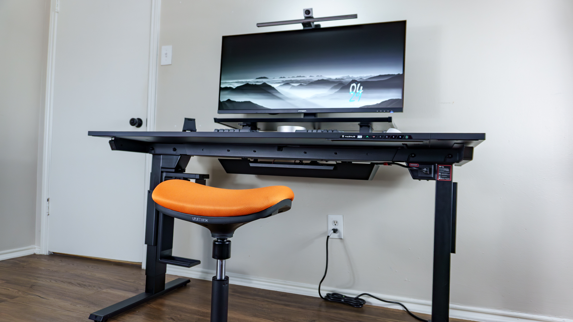 A saddle stool in front of a desk