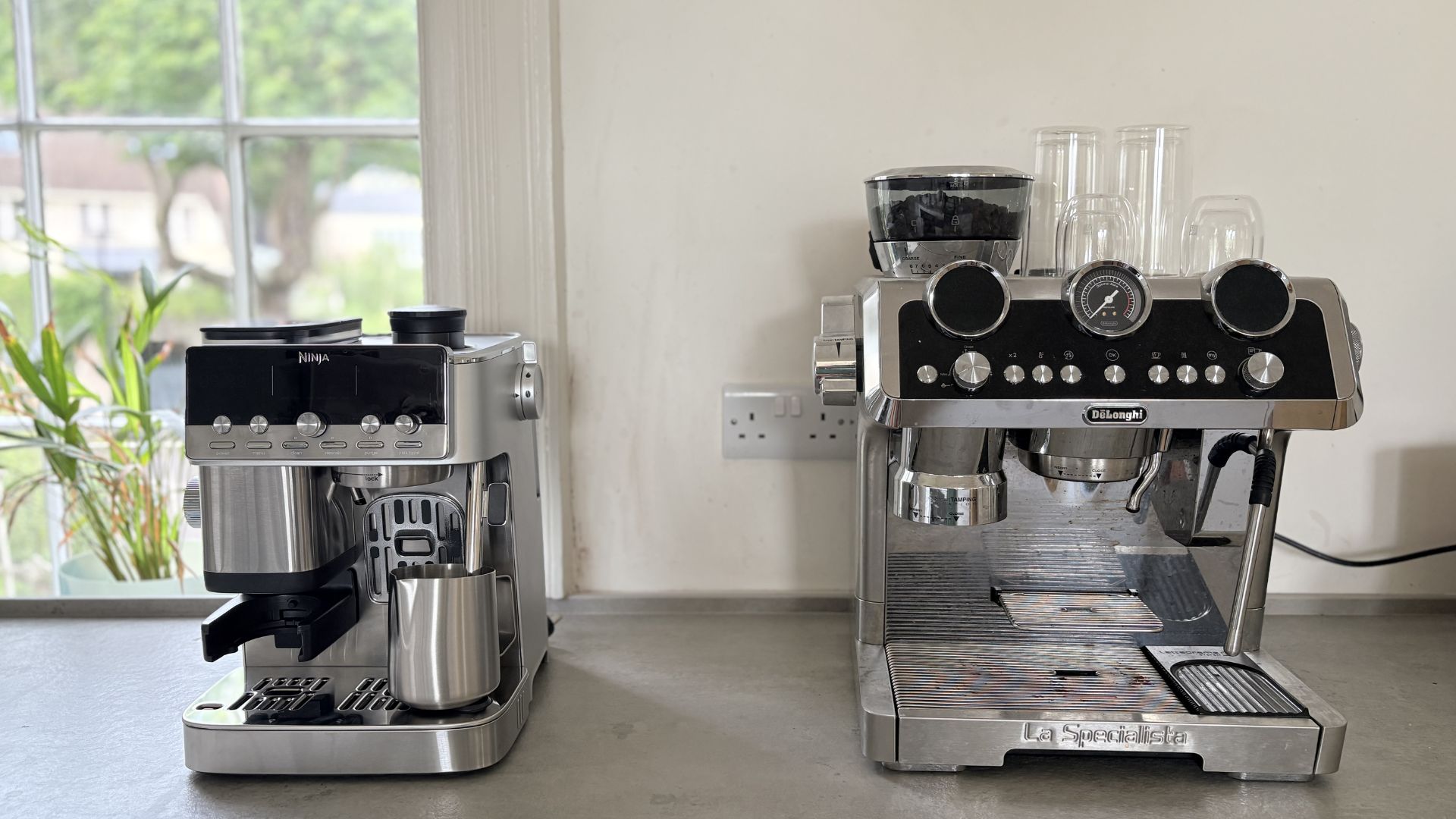 The Ninja Luxe Caf&amp;eacute; Mini Plus Espresso Machine next to the De'Longhi Maestro