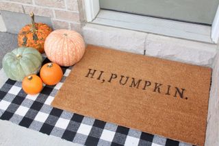 Doormat with hi pumpkin message on it