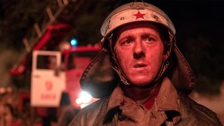 In a still image from the HBO miniseries 'Chernobyl,' a firefighter stares at the burning reactor building in the hours after the disaster began.