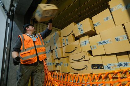 Amazon driver unloads boxes.