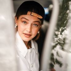 paris, france june 20 gigi hadid wears a brown cap, earrings, a white shirt outside vuitton, during paris fashion week menswear springsummer 2020, on june 20, 2019 in paris, france photo by edward berthelotgetty images