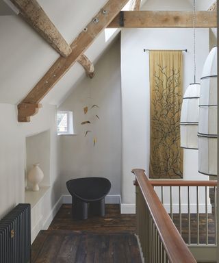 landing with accent armchair and mobile and exposed beams