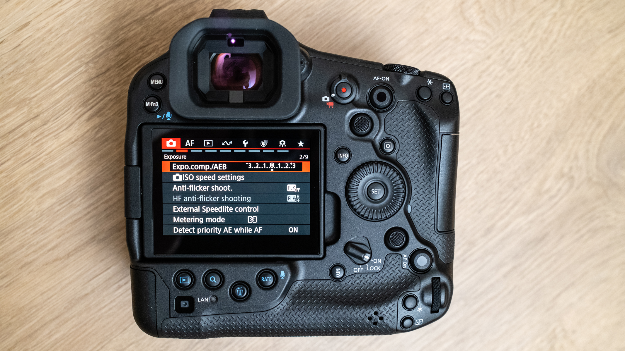 Canon EOS R1 rear view with LCD screen showing camera menu