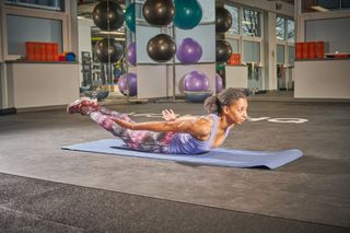 Female cyclist holding a back extension as part of a bone health boosting routine