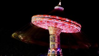 A lit-up swing ride spinning