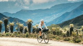 woman riding bikealong a track in colombia