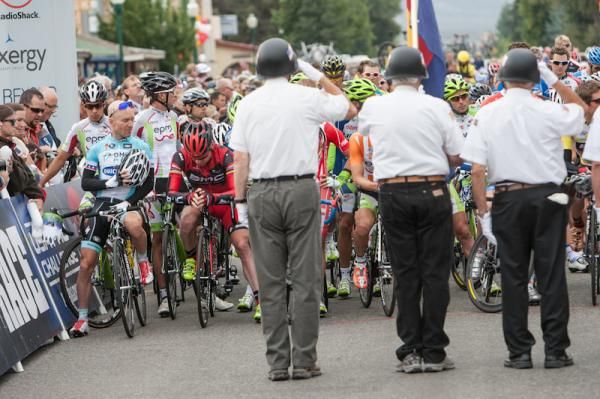 Riders listen to the National Anthem before the start.