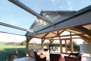 sunroom by IQ Glass features a glass link that connects it to the main house
