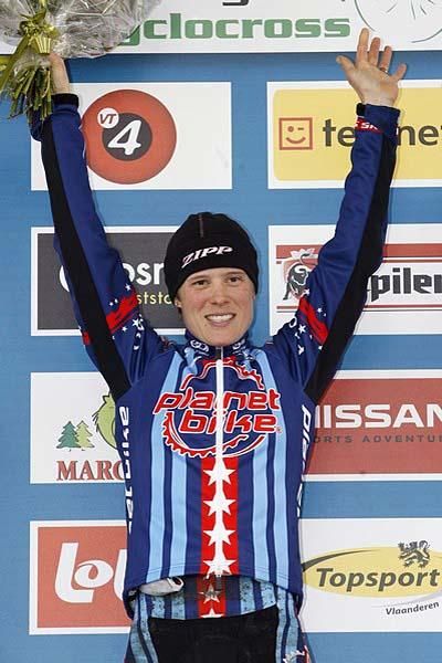 American Katie Compton stands atop the podium.