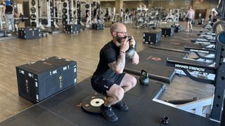 Miller Latvala, personal trainer for Life Time, demonstrates an elevated goblet squat