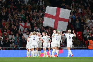 Lauren Hemp #9 of England celebrates scoring with teammates during a game between England and USWNT at Wembley Stadium on October 7, 2022 in London, England.