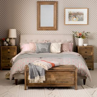 bedroom with bedside table and patterned wallpaper