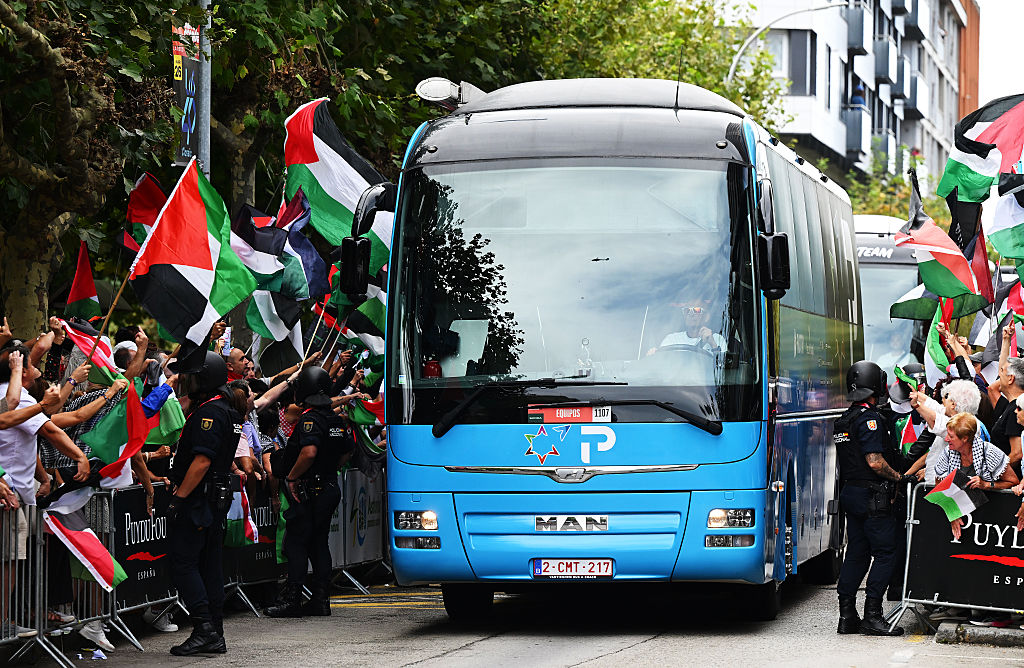 The police guard the bus of Team Israel - Premier Tech while the pro-Palestinians demonstrate prior to the La Vuelta - 80th Tour of Spain 2025