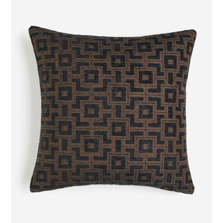 black and brown pillow with a geometric pattern