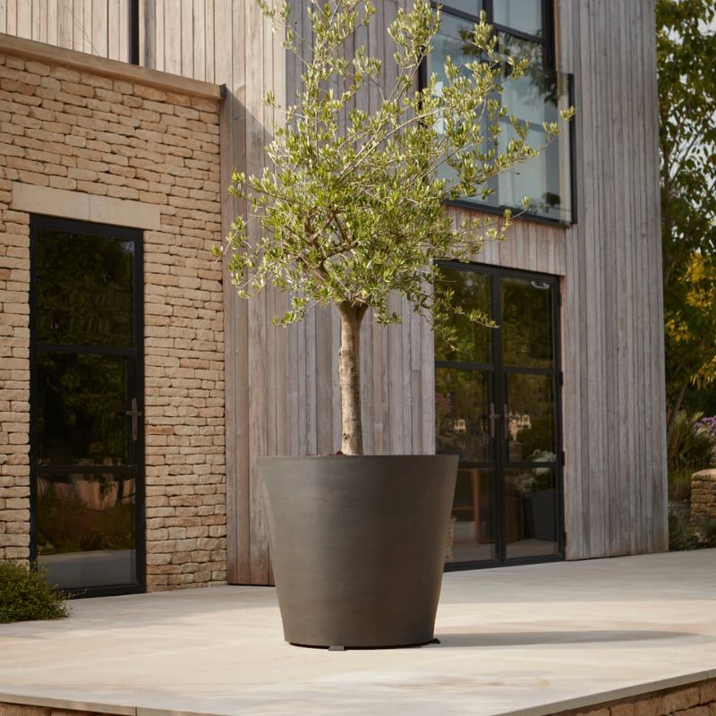 dark gray plant pot on wheels