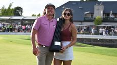 Cameron Smith and his wife Shanel Naoum Smith celebrate with a LIV Golf trophy