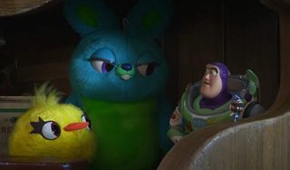 Toy Story 4 Ducky and Bunny look at Buzz Lightyear with a knowing smirk