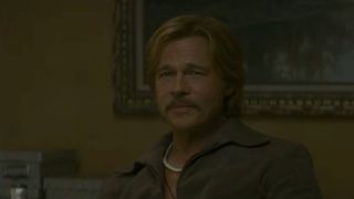 Brad Pitt with a mustache and smiling in The Further Mis-Adventures of Cliff Booth