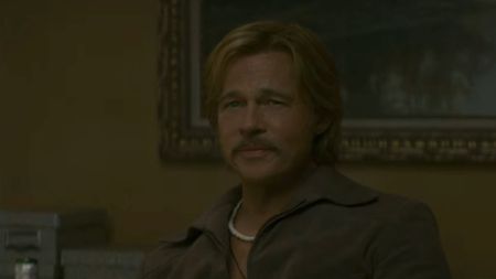 Brad Pitt with a mustache and smiling in The Further Mis-Adventures of Cliff Booth