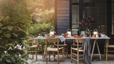 outdoor table set with glasses, plates, and napkins for a meal