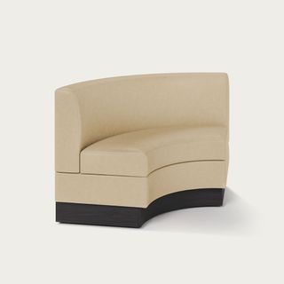 Cream, curved modular banquette seating with a black base