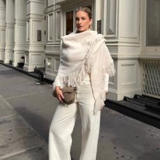 A woman in New York in a chic all-white winter outfit