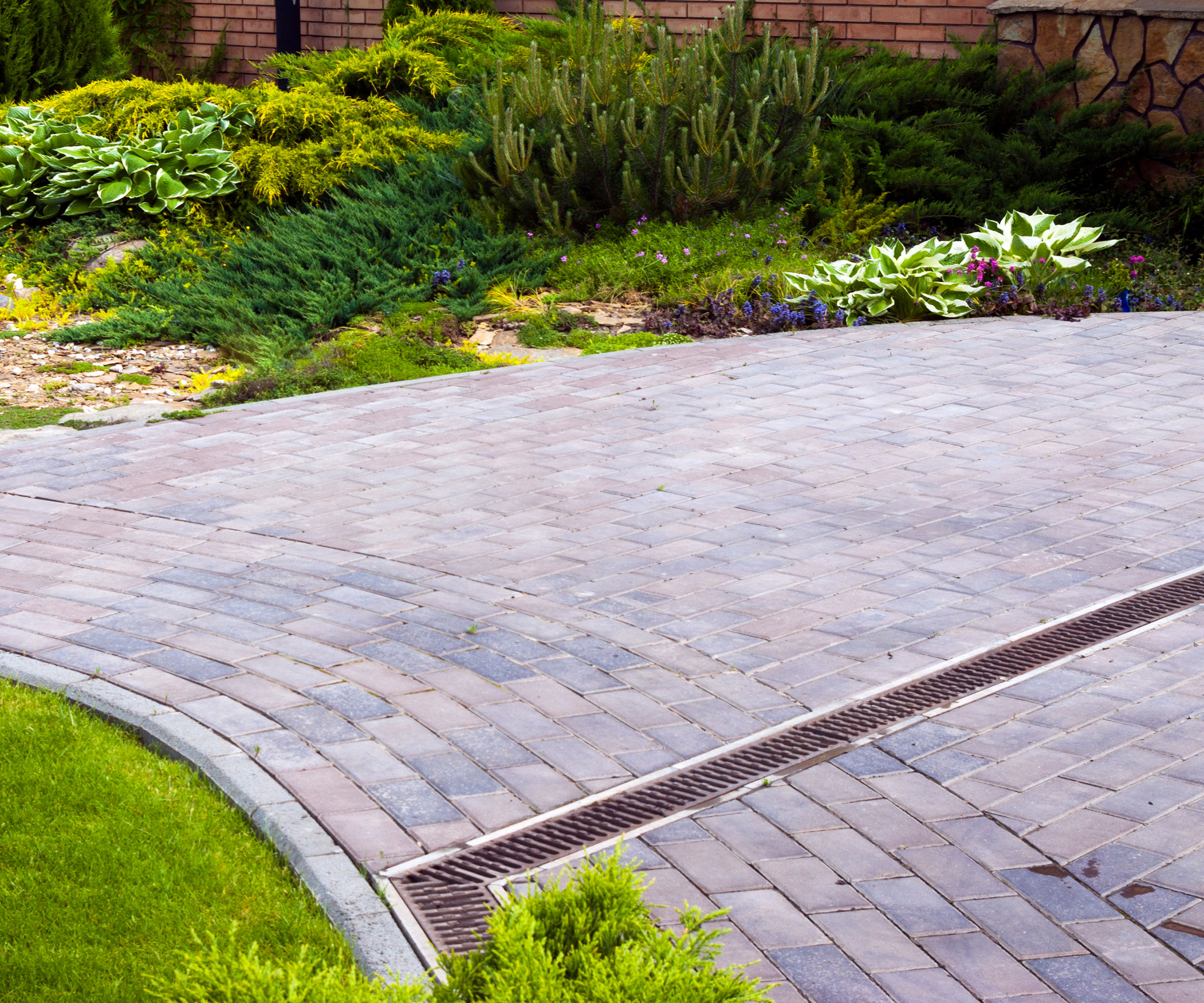sloped driveway with block paving and channel drains