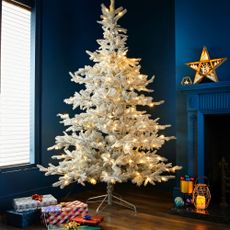 white christmas tree with light and gifts 