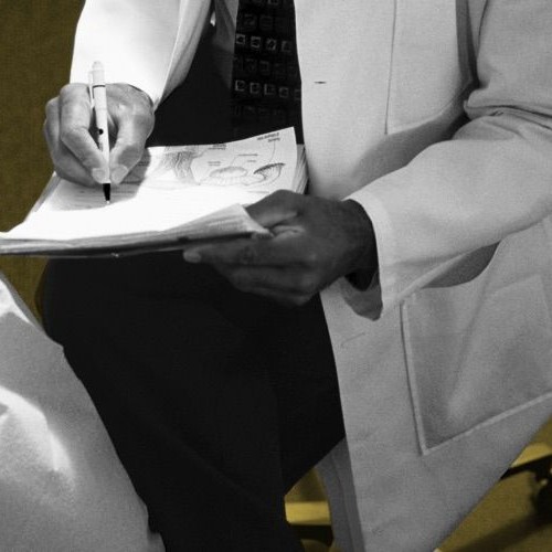 Gyno Sitting Writing on Pad