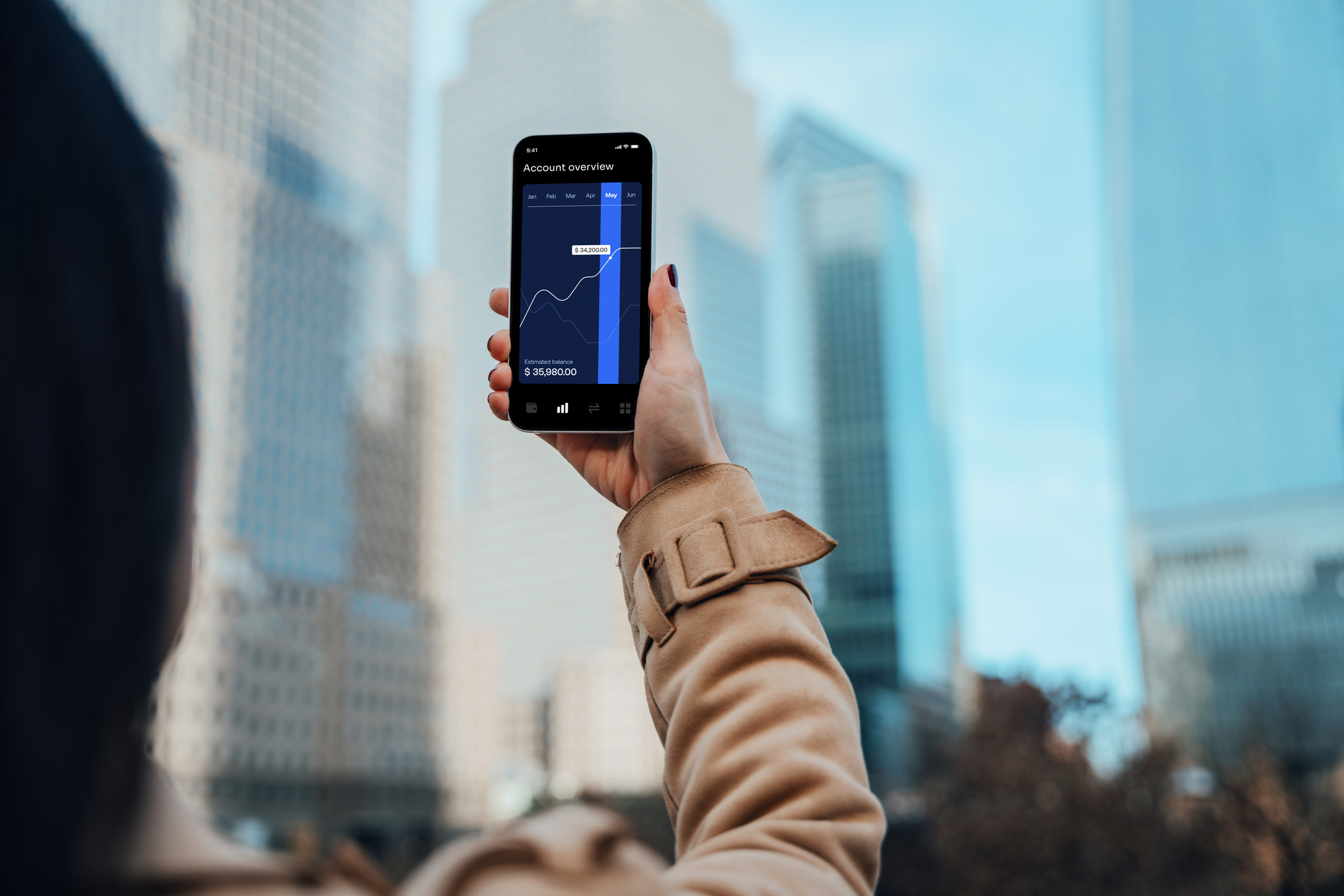 Woman using a smartphone to invest in low-cost index funds