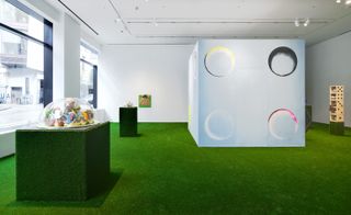 exhibition room with white wall and green carpet