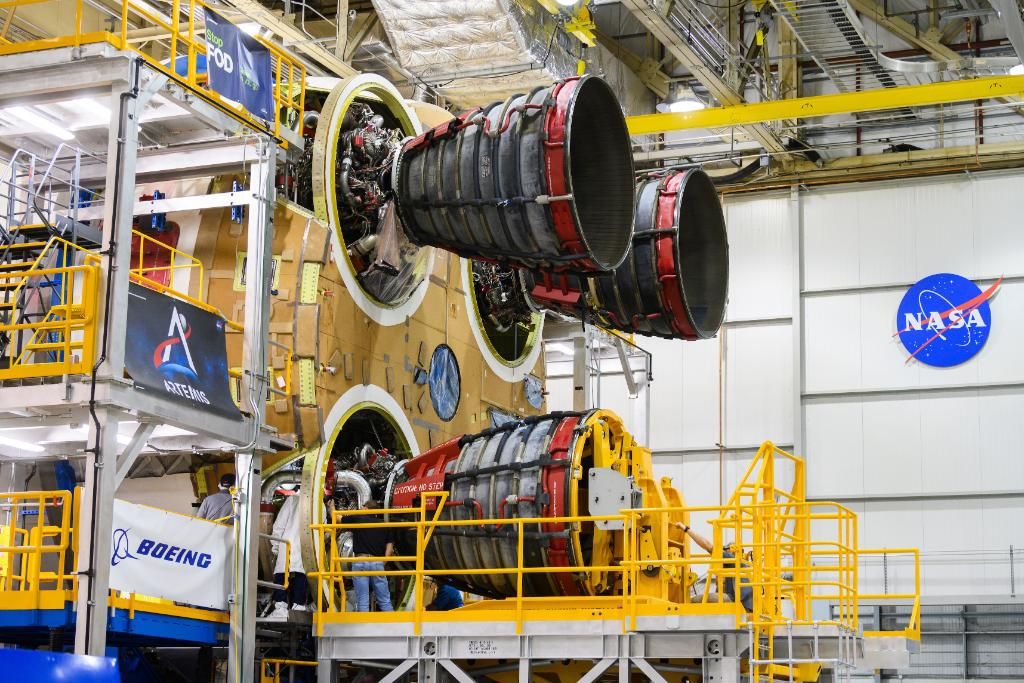 The third RS-25 rocket engine is seen attached to the core stage of NASA's first Space Launch System rocket.
