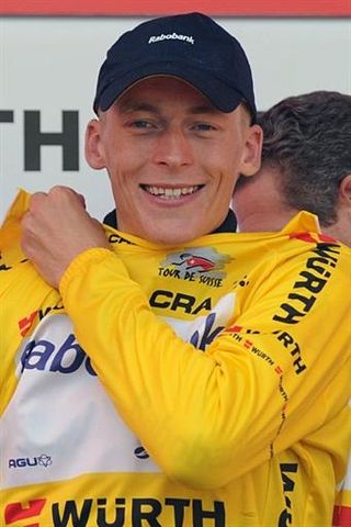 Robert Gesink (Rabobank) dons the leader's jersey of the Tour de Suisse.