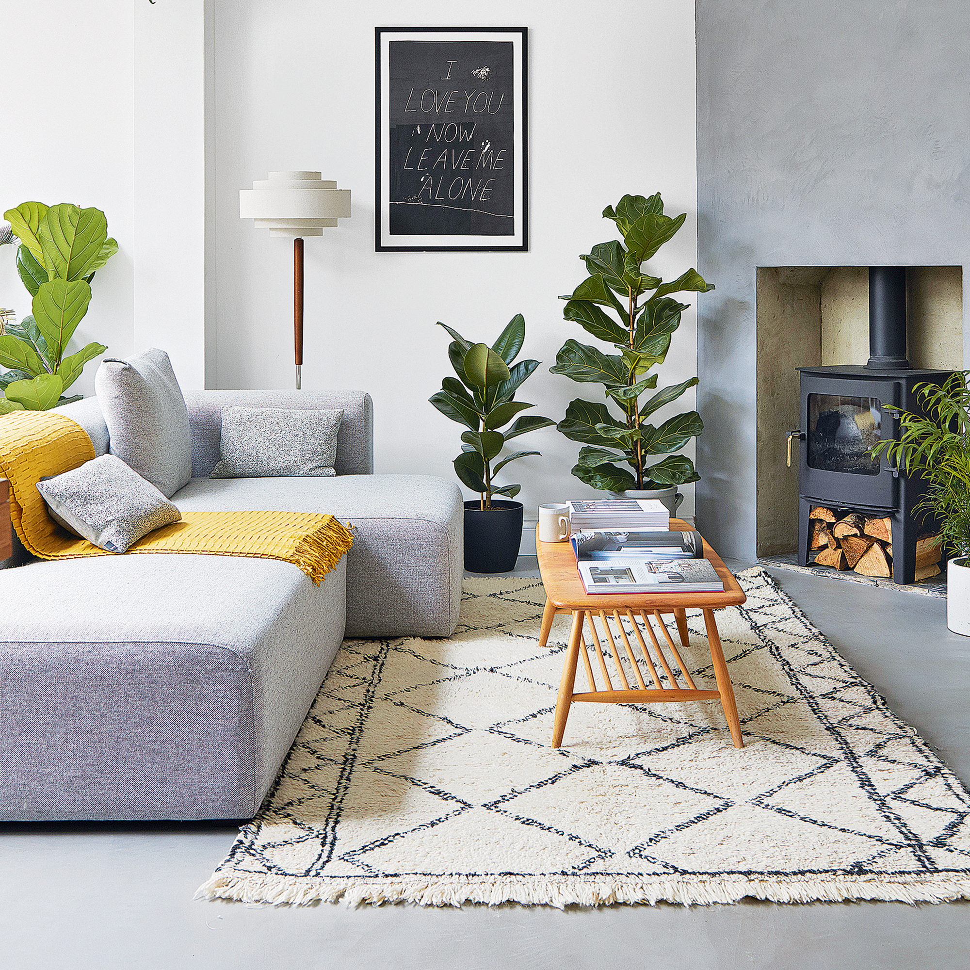Modern living room with grey modular sofa on a concrete floor