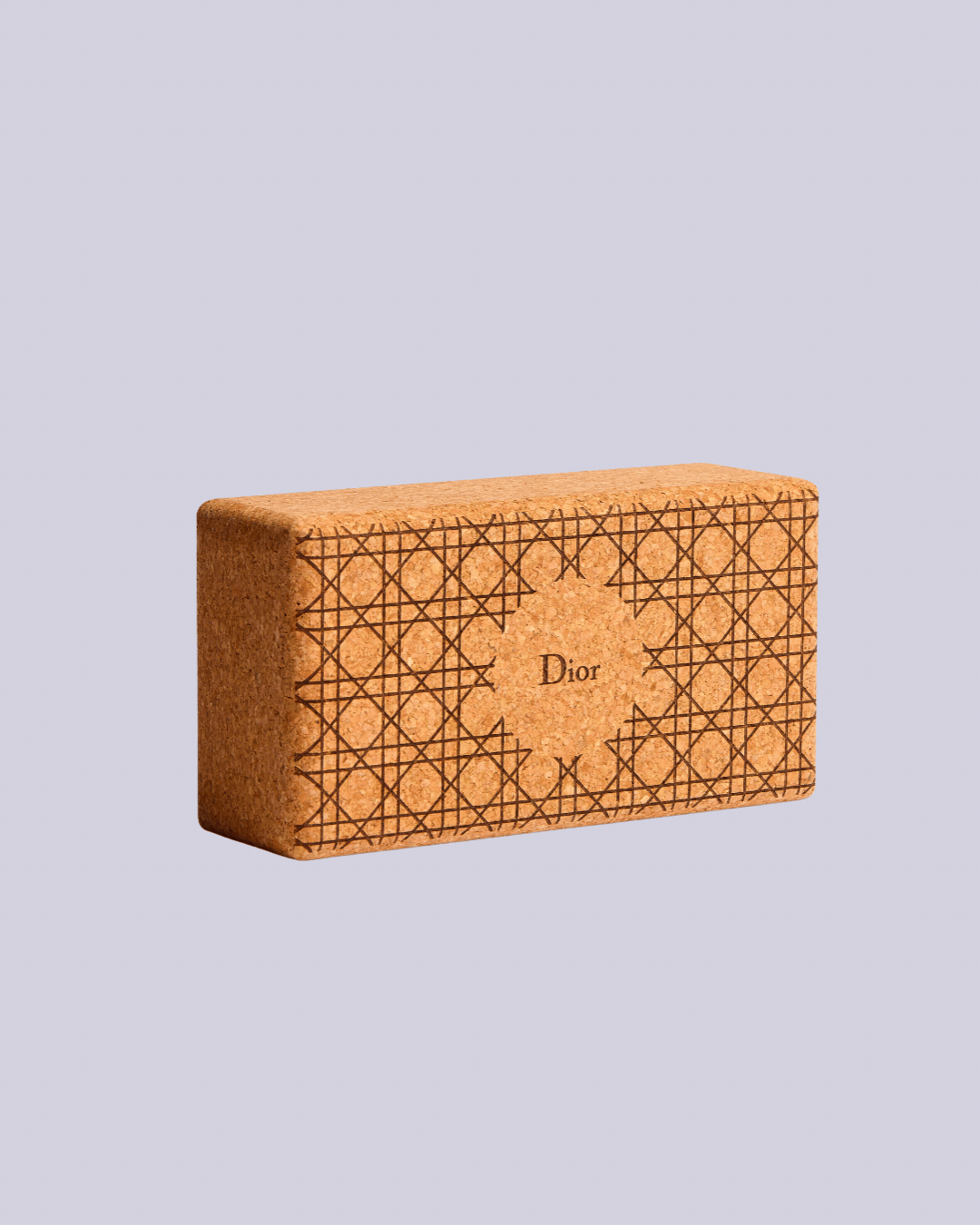 A rotating gif showcasing a cork yoga block with a checkered design and the logo "Dior".