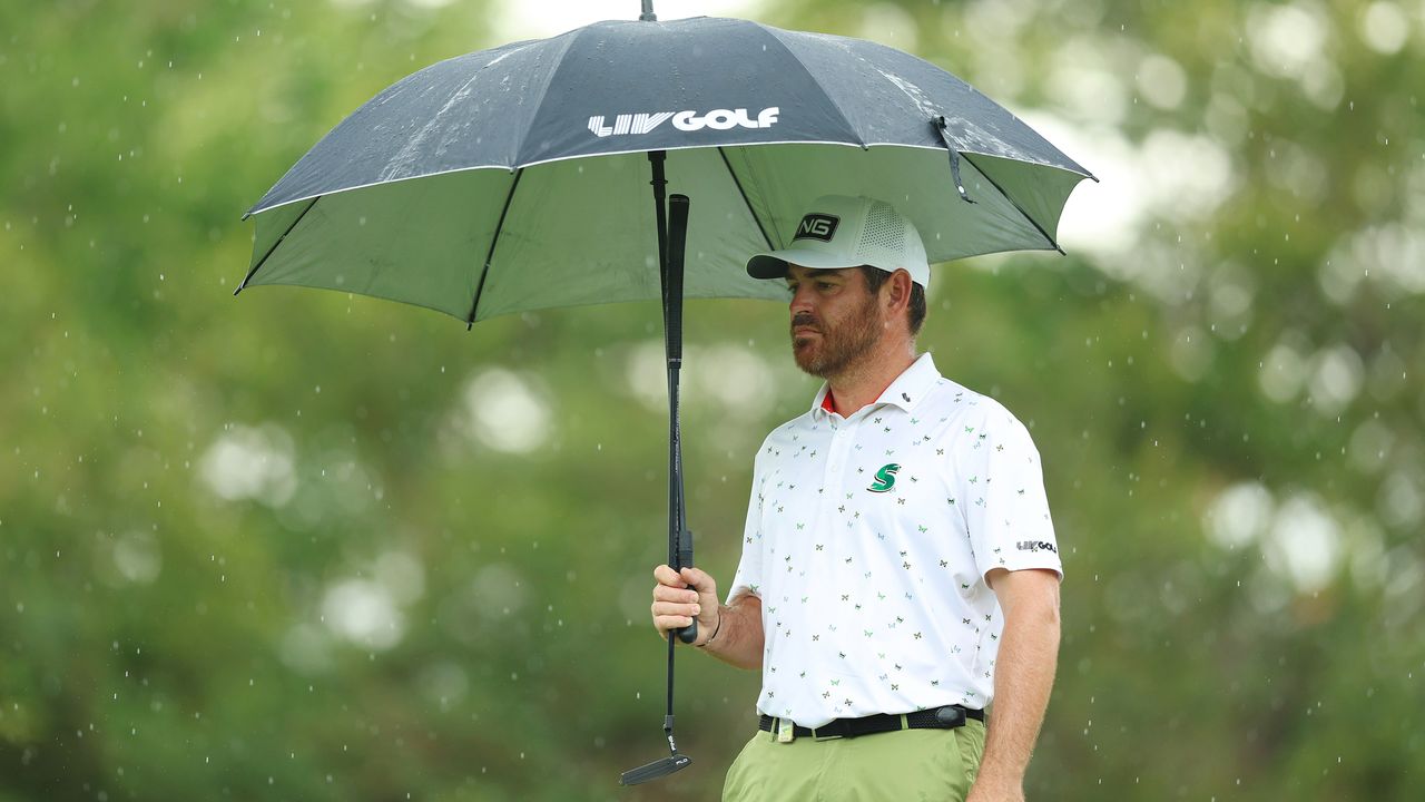 South Africa&#039;s Louis Oosthuizen holds up a LIV Golf umbrella during the final round of the DP World Tour&#039;s Alfred Dunhill Championship at Leopards Creek Country Club