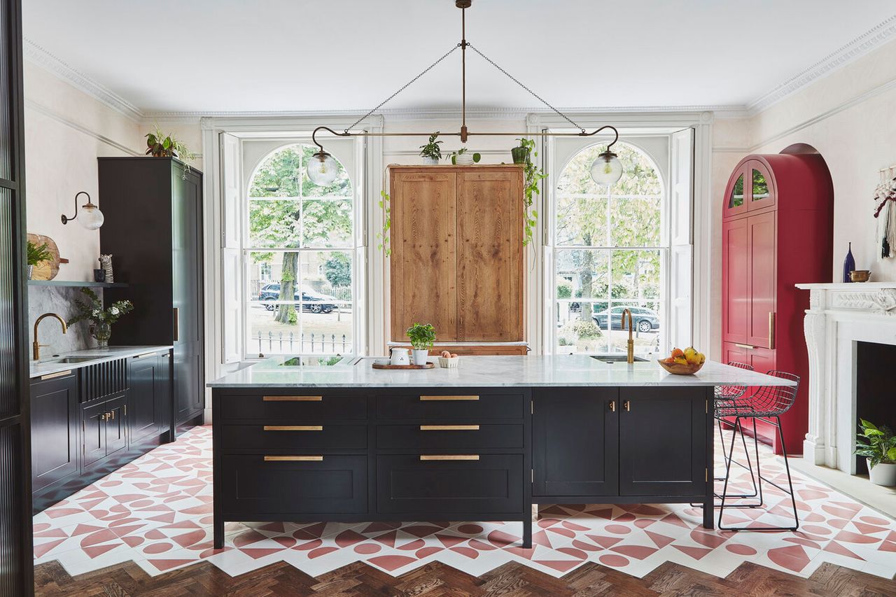 a colorful kitchen with a large pendant light over the island