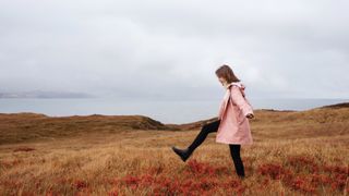 woman walks in heather