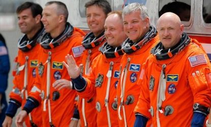 The Endeavor's astronauts, including Gabrielle Giffords' husband Commander Mark Kelly (right), were all suited up but the launch was postponed for technical reasons.