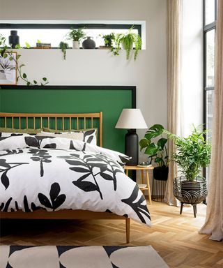 Bedroom paint ideas with green painted headboard with shelving and greenery