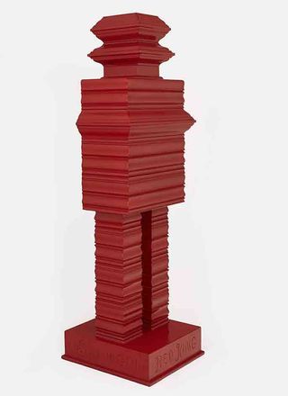 Red wooden sculpture, set on a plinth with engraving 'Red King' , white background