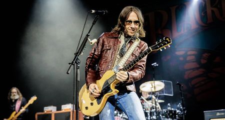 Charlie Starr of Blackberry Smoke wears shades and a brown leather jacket as he plays his TV Yellow Gibson Les Paul Junior live onstage.