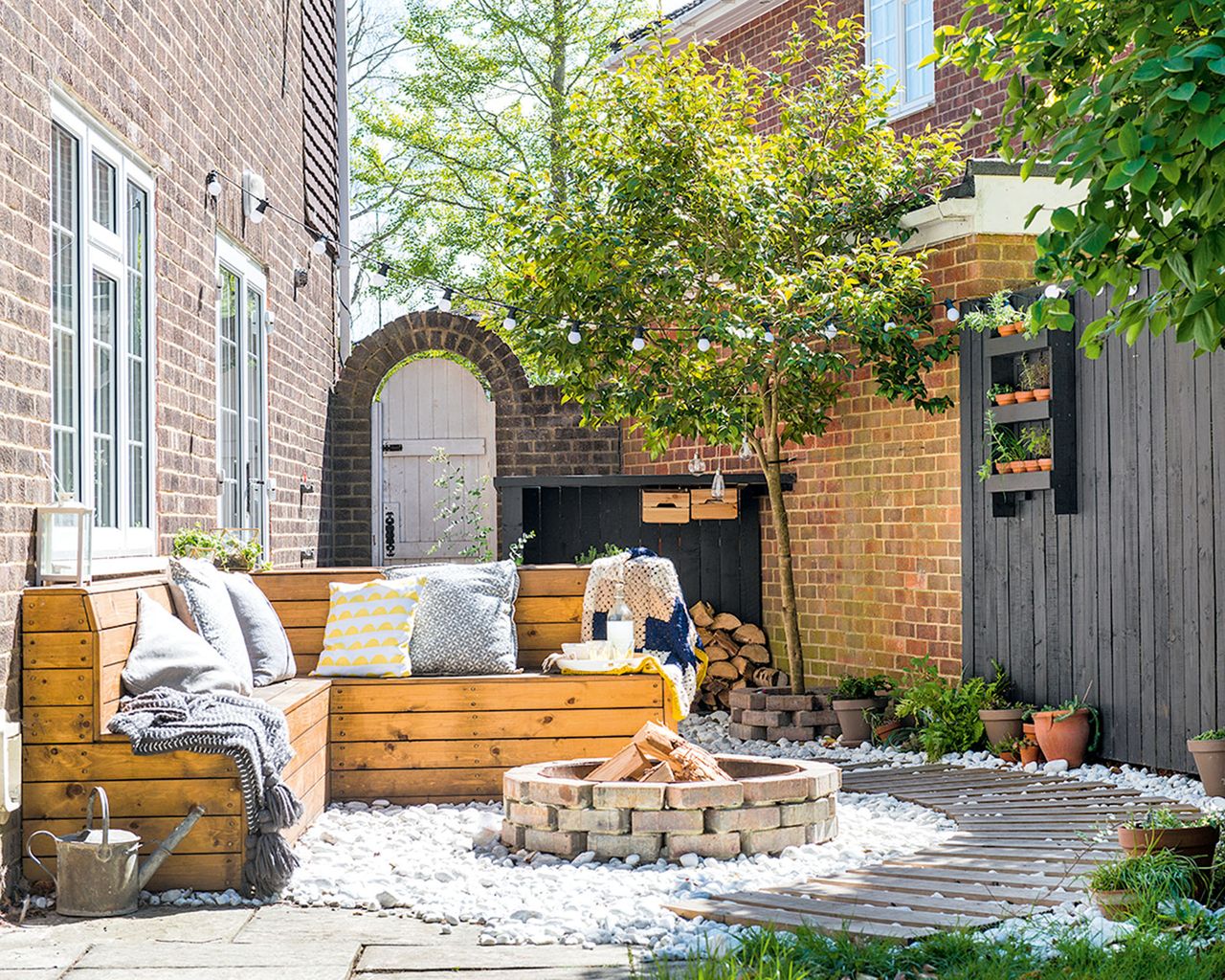 A small side garden transformed into a patio seating area with brick firepit