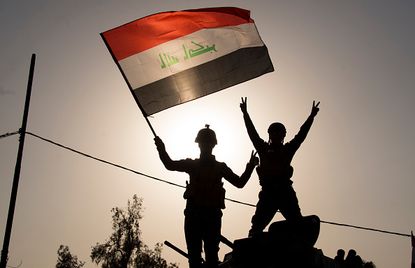Iraqi troops celebrate recapturing Mosul.