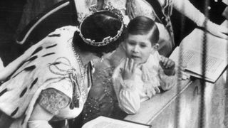 Queen Elizabeth, the Queen Mother talking to her grandson, Prince Charles, during the coronation while Princess Margaret looks on
